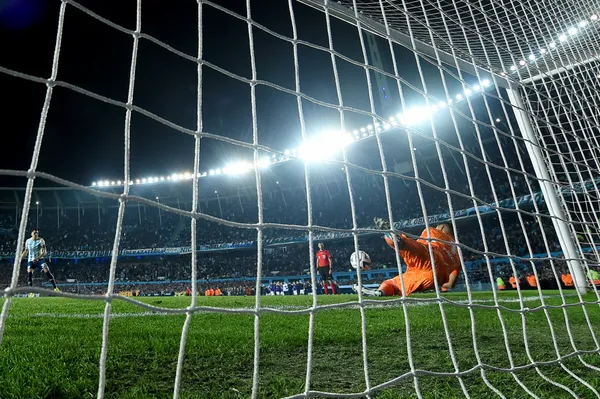 AVELLANEDA, ARGENTINA - AUGUST 30: (EDITORS NOTE: In this photo taken from a remote camera from behind the goal.) Goalkeeper Sergio Romero of Boca Juniors saves a penalty in the shoot-out during a second leg quarter final match between Racing Club and Boca Juniors as part of Copa CONMEBOL Libertadores 2023 at Presidente Peron Stadium on August 30, 2023 in Avellaneda, Argentina. (Photo by Marcelo Endelli/Getty Images)