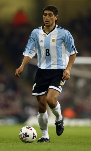 13 Feb 2002: Juan Roman Riquelme of Argentina runs with the ball during the International Friendly match against Wales played at the Millennium Stadium, in Cardiff, Wales. The match ended in a 1-1 draw. DIGITAL IMAGE. Mandatory Credit: Phil Cole/Getty Images