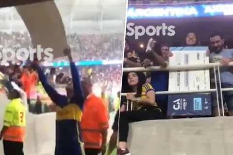 Marcos Rojo regalandole el cheque de Copa Argentina a una hincha de Boca
